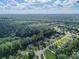 Aerial view of the home, neighborhood, and surrounding wooded areas on a sunny day at 6417 Loyola Ct, Mint Hill, NC 28227