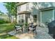 Backyard patio area with outdoor furniture set on a concrete patio with grassy space and partial shade at 6417 Loyola Ct, Mint Hill, NC 28227