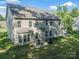 Aerial view of backyard showing patio, grill, grassy area, and home's exterior at 6417 Loyola Ct, Mint Hill, NC 28227
