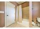 Bathroom with tile flooring and shower-tub combination, features a neutral shower curtain and door to the exterior at 6417 Loyola Ct, Mint Hill, NC 28227