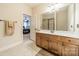 Bathroom with a spacious vanity, neutral tile flooring, and an open doorway to another room at 6417 Loyola Ct, Mint Hill, NC 28227