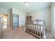 A well-lit bedroom features neutral colors, a light wood bed, built-in shelving, and plush carpeting at 6417 Loyola Ct, Mint Hill, NC 28227