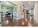 Welcoming foyer with hardwood floors, staircase, and an open view to the living room and office at 6417 Loyola Ct, Mint Hill, NC 28227
