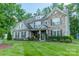 Charming two-story home with stone details, well-kept lawn, and inviting front porch at 6417 Loyola Ct, Mint Hill, NC 28227
