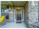 Inviting front door with stone surround, decorative wreath, and welcome mat at 6417 Loyola Ct, Mint Hill, NC 28227