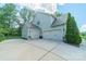 Spacious three car garage with concrete driveway and manicured landscaping at 6417 Loyola Ct, Mint Hill, NC 28227
