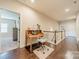 Hallway showing desk space and hardwood flooring, with doorway leading to bedroom at 6417 Loyola Ct, Mint Hill, NC 28227