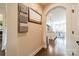Hallway view into the kitchen with hardwood floors, neutral walls, and archway at 6417 Loyola Ct, Mint Hill, NC 28227