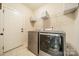 Laundry room features modern, front-loading washer and dryer and storage shelves at 6417 Loyola Ct, Mint Hill, NC 28227