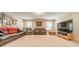 Spacious living area with neutral walls and carpet, featuring couches, armchair, TV and natural light at 6417 Loyola Ct, Mint Hill, NC 28227