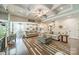 Open living room with coffered ceilings, hardwood floors, and view into kitchen at 6417 Loyola Ct, Mint Hill, NC 28227