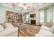 Cozy living room features fireplace, built-in bookshelves, and neutral decor at 6417 Loyola Ct, Mint Hill, NC 28227