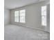 Bright bedroom featuring neutral carpeting and two large windows providing natural light at 764 Atherton Way, Rock Hill, SC 29730