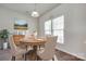 Well-lit dining room featuring a round wooden table, beige chairs, and natural light from the double windows at 764 Atherton Way, Rock Hill, SC 29730