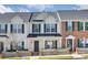Charming townhome with white siding, black shutters, and a well-manicured lawn and picket fence at 764 Atherton Way, Rock Hill, SC 29730