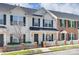 Charming townhouse exterior featuring a white picket fence, dark shutters, and well-maintained landscaping at 764 Atherton Way, Rock Hill, SC 29730