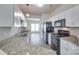 Modern kitchen with granite countertops, white cabinets, and black appliances at 764 Atherton Way, Rock Hill, SC 29730
