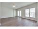 Bright living room featuring hardwood floors, neutral walls, ceiling fan and abundant natural light from the windows at 764 Atherton Way, Rock Hill, SC 29730