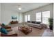 Spacious living room with neutral tones, ceiling fan, and ample natural light from large windows and patio doors at 764 Atherton Way, Rock Hill, SC 29730