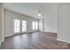Bright living room featuring hardwood floors, neutral walls, ceiling fan and abundant natural light from the windows at 764 Atherton Way, Rock Hill, SC 29730
