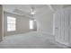 Spacious main bedroom with neutral carpet, a ceiling fan, and two large windows for natural light at 764 Atherton Way, Rock Hill, SC 29730