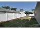 Spacious backyard surrounded by a pristine white privacy fence with well maintained grass at 8655 Meadowmont View Dr, Charlotte, NC 28269