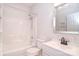Clean bathroom with tub and shower combination with a framed mirror and updated sink at 8655 Meadowmont View Dr, Charlotte, NC 28269