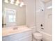 Bathroom featuring modern subway tile in shower, tiled floors, and modern lighting at 8655 Meadowmont View Dr, Charlotte, NC 28269