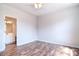 Spacious bedroom showcasing wood-look flooring and open access to an ensuite bathroom at 8655 Meadowmont View Dr, Charlotte, NC 28269