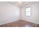 Bedroom with hardwood style flooring, a ceiling fan, and a window at 8655 Meadowmont View Dr, Charlotte, NC 28269