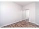 Spacious bedroom featuring wood-look flooring and a closet with mirrored sliding doors at 8655 Meadowmont View Dr, Charlotte, NC 28269