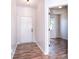 Bright entryway featuring modern wood flooring and a neutral color scheme, leading to the rest of the home at 8655 Meadowmont View Dr, Charlotte, NC 28269