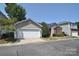 This property offers a well-maintained front yard and is conveniently located near essential amenities at 8655 Meadowmont View Dr, Charlotte, NC 28269
