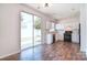 Bright kitchen with white cabinets, modern appliances, and wood floors, offering a functional space for culinary endeavors at 8655 Meadowmont View Dr, Charlotte, NC 28269