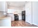Bright kitchen features white cabinetry, stainless steel dishwasher, and wood-look laminate flooring at 8655 Meadowmont View Dr, Charlotte, NC 28269