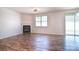 Inviting living room featuring a cozy fireplace, wood-look flooring, and a sliding door for ample natural light at 8655 Meadowmont View Dr, Charlotte, NC 28269