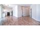 Spacious open-concept living area featuring wood-look floors, seamlessly connecting to the kitchen and dining spaces at 8655 Meadowmont View Dr, Charlotte, NC 28269