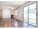 Bright living room with wood floors, a fireplace, and sliding glass doors providing access to the outdoor area at 8655 Meadowmont View Dr, Charlotte, NC 28269