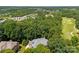 Aerial view of a home surrounded by lush greenery, golf course, and neighborhood at 10007 Hillspring Dr, Huntersville, NC 28078