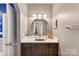 Bathroom with single sink vanity and updated lighting at 10007 Hillspring Dr, Huntersville, NC 28078