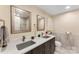 Bathroom featuring dual sinks, granite countertops, and updated fixtures at 10007 Hillspring Dr, Huntersville, NC 28078