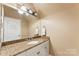 Bathroom featuring tile countertops, single sink vanity, and new fixtures at 10007 Hillspring Dr, Huntersville, NC 28078