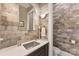 Modern bathroom with a stylish stone wall, sleek fixtures, and a minimalist design at 10007 Hillspring Dr, Huntersville, NC 28078