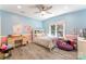 Bedroom with pastel walls, hardwood floors, and natural light at 10007 Hillspring Dr, Huntersville, NC 28078