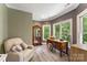 Bedroom with chair, desk, hardwood floors, mirror and natural light at 10007 Hillspring Dr, Huntersville, NC 28078