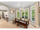Cozy breakfast nook filled with light, featuring a long wood table and views of the backyard at 10007 Hillspring Dr, Huntersville, NC 28078