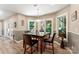 Bright breakfast nook featuring a stylish table with four chairs and natural light from the windows at 10007 Hillspring Dr, Huntersville, NC 28078