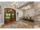 Elegant dining room featuring a stone accent wall, wood floors, and a large dining table at 10007 Hillspring Dr, Huntersville, NC 28078