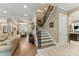 Inviting home foyer with hardwood floors and a staircase to the upper level at 10007 Hillspring Dr, Huntersville, NC 28078