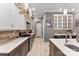 Open kitchen with stone backsplash, white cabinets, and modern countertops at 10007 Hillspring Dr, Huntersville, NC 28078